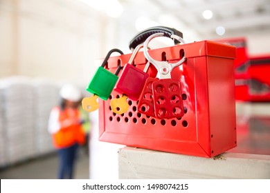 Female Hand Holding Red Safe Lockout And Tagout Box