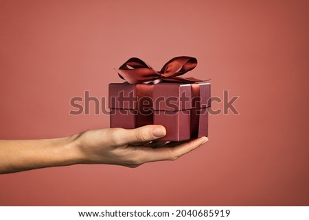 Similar – Image, Stock Photo Hand with a gift on pink background with copy space