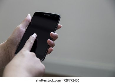 Female hand holding the smartphone Black color
 - Shutterstock ID 729772456
