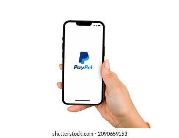 Female Hand Holding A Smartphone IPhone 13 Pro With PayPal App On The Screen. White Background. Rio De Janeiro, RJ, Brazil. November 2021.