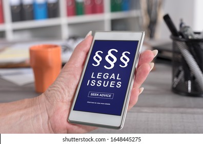 Female Hand Holding A Smartphone With Legal Issues Concept