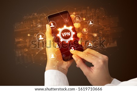 Female hand holding smartphone with VPN abbreviation, modern technology concept