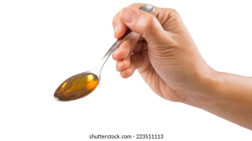 Female Hand Holding A Spoon Of Honey Over White Background