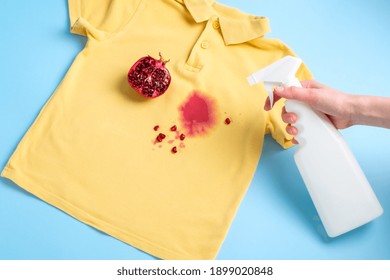 Female Hand Holding A Stain Remover To Remove A Dirty Stain From On Clothes. Daily Life Dirty Stain For Wash And Clean Concept. High Quality Photo