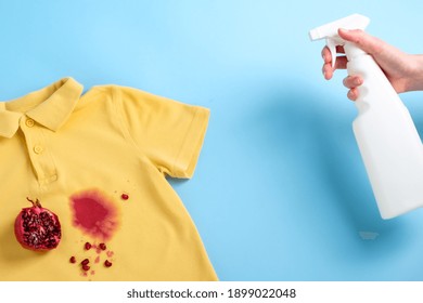 Female Hand Holding A Stain Remover To Remove A Dirty Stain From On Clothes. Daily Life Dirty Stain For Wash And Clean Concept. High Quality Photo