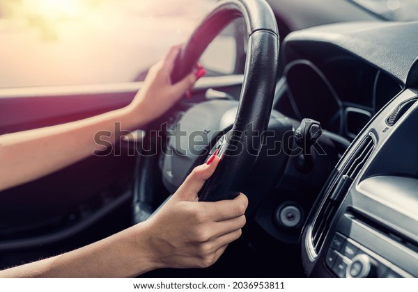 female hand holding steering wheel. Close-up. Travel\
concept  