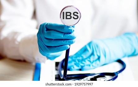 Female Hand Holding Stethoscope With Text IBS Health Concept