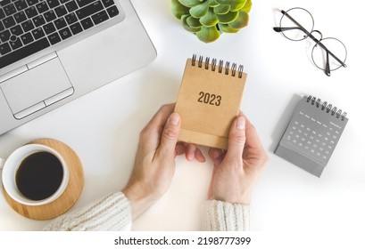 female hand holding table calendar. To-do list and plans for 2023 Goals for next year. - Shutterstock ID 2198777399