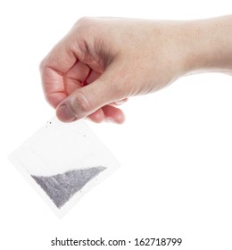 Female Hand Holding Teabag Isolated On White Background