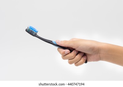 Female Hand Holding A Toothbrush With Toothpaste  Isolated On White Background