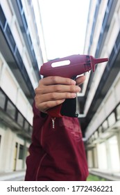 Female Hand Holding Toy Gun Made Of Plastic.