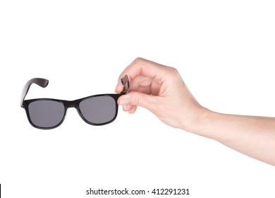 Female hand holding wayfarer sunglasses over white