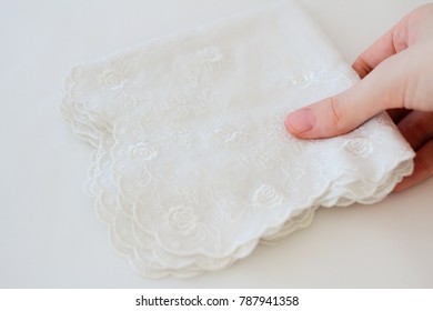 Female Hand Holding A White Handkerchief