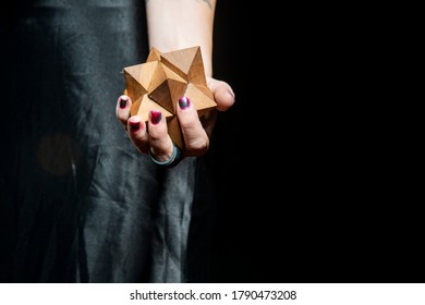 Female Hand Holding A Wooden 3D Puzzle