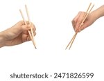 Female hand holding wooden sushi chopsticks isolated on a white background. 