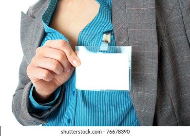 Female Hand Holds Blank Name Badge, Wears Blue Shirt And Grey Suit