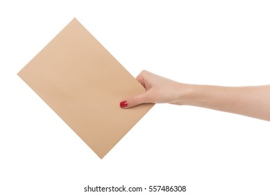 Female hand holds an envelope. Isolated on white background.