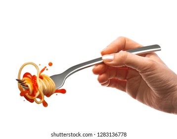 Female Hand Holds A Fork With Spaghetti Pasta And Splash Of Tomato Sauce.