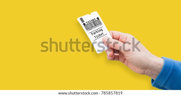 Female\
hand holds a parking ticket on solid colored background - image\
with copy space - Bar Code is totally invented and does not contain\
brand names, links, phrases covered by\
copyright