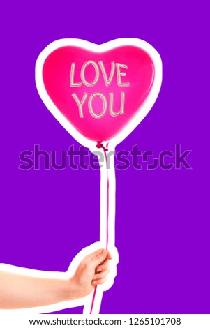 Female hand holds red rubber inflatable heart shape balloon. Love, relationship, valentines day and birthday celebration concept. Magazine style fashion collage with blank copy space