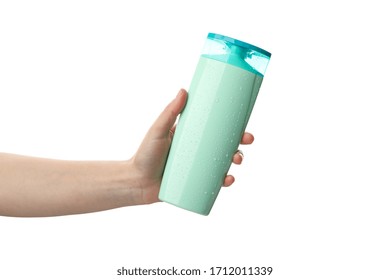 Female Hand Holds Shampoo Bottle, Isolated On White Background