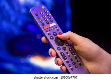 Female Hand Holds A Smart TV Remote With Microphone And Voice Control.