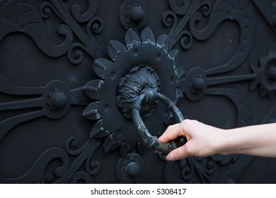 Female Hand Knocking On A Closed Door