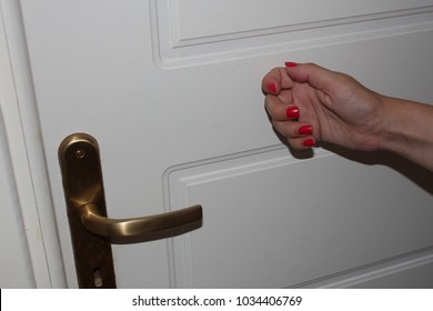 Female Hand Knocking On Door.