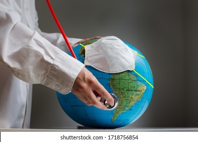 Female Doctor’s Hand Listens To The Breath Of The Earth Ballon, A Symbol Of Environmental, Epidemiological And Political Problems