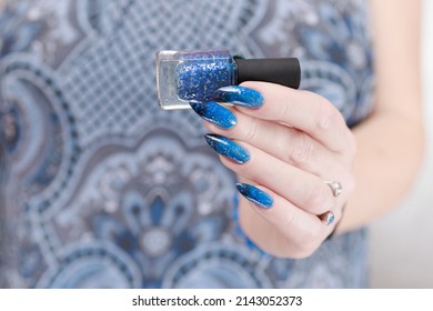 Female hand and long nails   blue  black thermo french nail polish