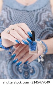 Female hand and long nails   blue  black thermo french nail polish