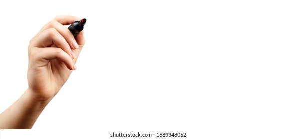 female hand with marker write on an isolated white background. Writing hand. Hand holding black Pen. Wide image.