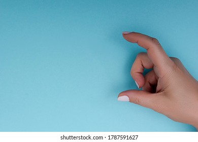 Female Hand Measuring Or Holding Invisible Item While Showing Small Amount Of Something 