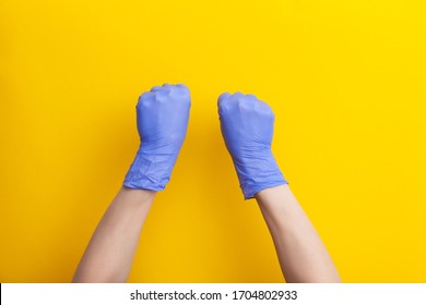 Female Hand In Medical Glove Is Clenched Into Fist