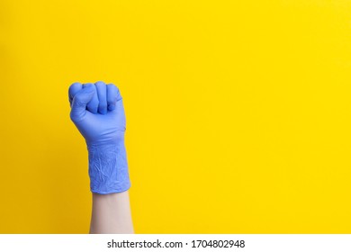 Female Hand In Medical Glove Is Clenched Into Fist