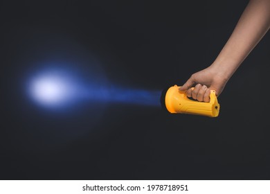 Female Hand With Modern Flashlight On Dark Background