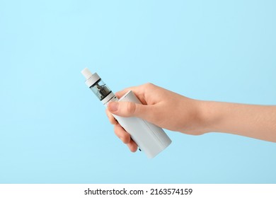 Female Hand With Modern Vape Mod On Blue Background