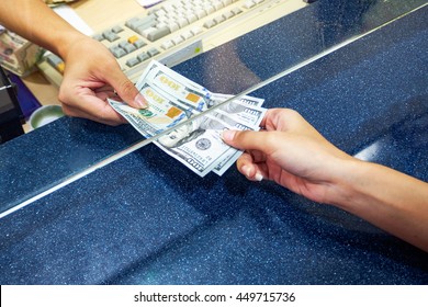 Female Hand With Money In Cash Department Window. Currency Exchange Concept. American Dollar. Us Dollar.  Cash On Counter Bank. Hand Giving Cash And Hand Receiving Cash. Payday  Paying Cashier Access
