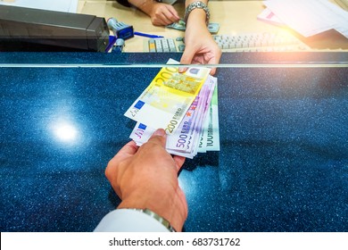 Female Hand With Money In Cash Department Window. Currency Exchange Concept. Euro Banknote. EUR . Cash On Counter Bank. Hand Giving Cash And Hand Receiving Cash. Payday Paying Cashier Access