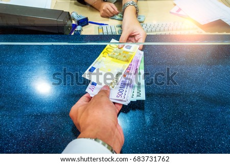 Female hand with money in cash department window. Currency exchange concept. Euro banknote. EUR . cash on counter bank. Hand giving cash and hand receiving cash. payday paying cashier access