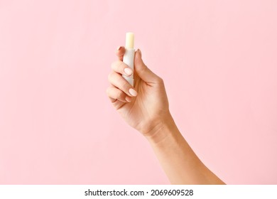 Female Hand With Natural Lip Balm On Color Background