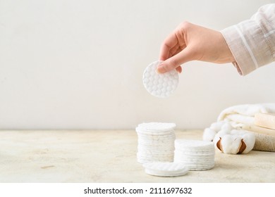 Female hand with new clean cotton pad on light background - Shutterstock ID 2111697632