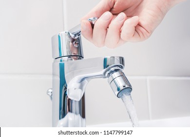 Female Hand On The Handle Of A Chrome Faucet With Running Water - Shutterstock ID 1147799147
