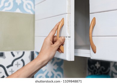 Female Hand Open The Cupboard Doors, Close Up