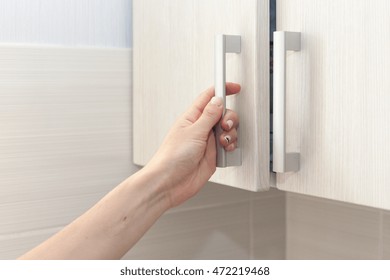 Female Hand Open The Cupboard Doors, Close Up