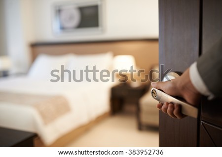 Female hand opening hotel room, selective focus