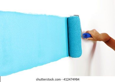 Female Hand Painting Wall With Paint Roller