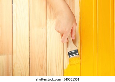 Female Hand Painting Wood With Brush