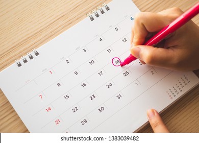 Female Hand With Pen Mark On Calendar Date