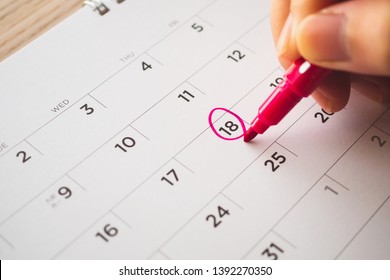 Female Hand With Pen Mark On Calendar Date